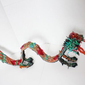 A dragon made of paper and yarn.
