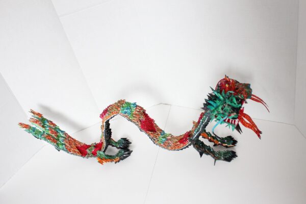 A dragon made of paper and yarn.