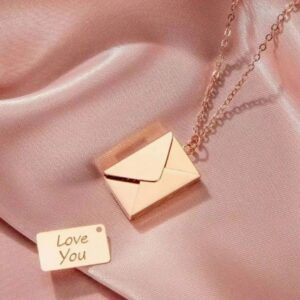 A necklace that is sitting on top of a pink cloth.