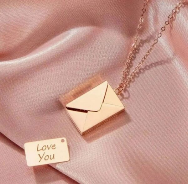 A necklace that is sitting on top of a pink cloth.