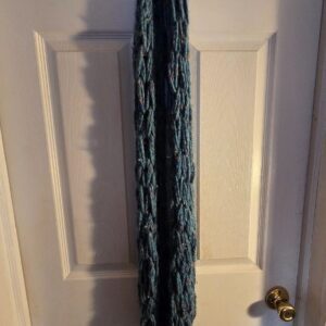 A door with a white and blue curtain hanging on it.