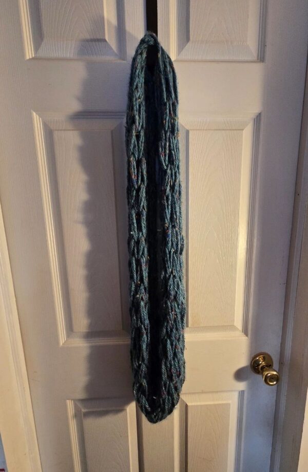 A door with a white and blue curtain hanging on it.