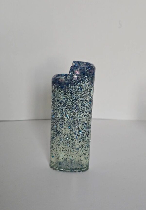 A glass vase with blue and white speckles on it.