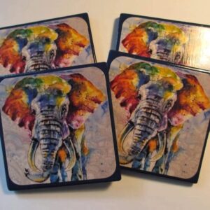 A set of four coasters with an elephant painting on them.