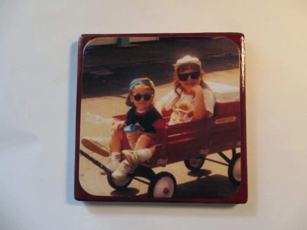 A picture of two girls sitting in a wagon.