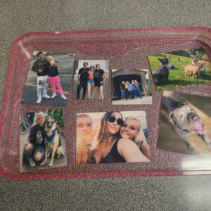A tray with pictures of people and dogs on it.