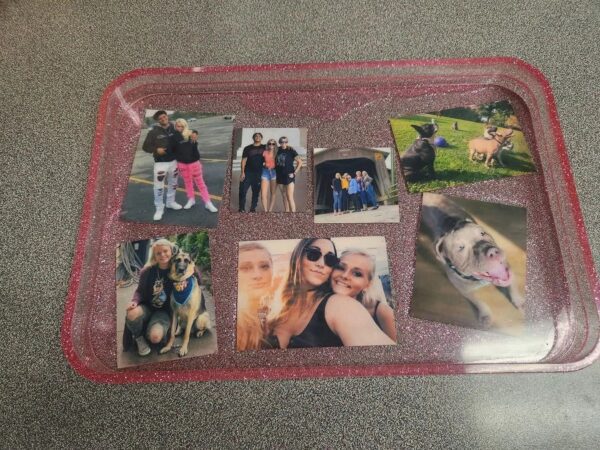A tray with pictures of people and dogs on it.