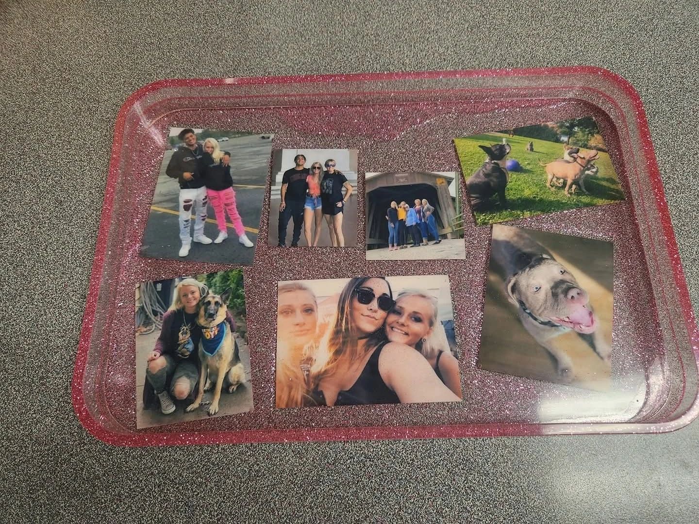 A tray with pictures of people and dogs on it.