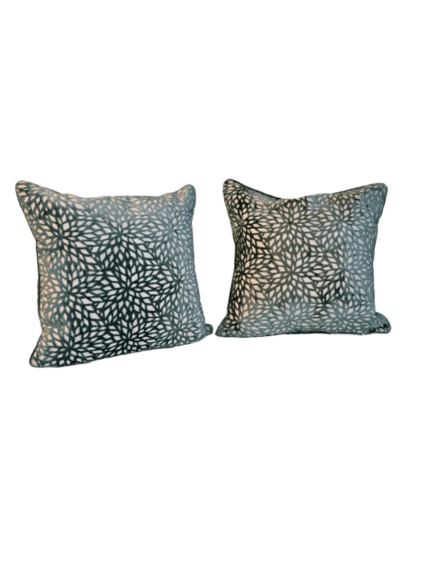 A pair of pillows with animal print on them.