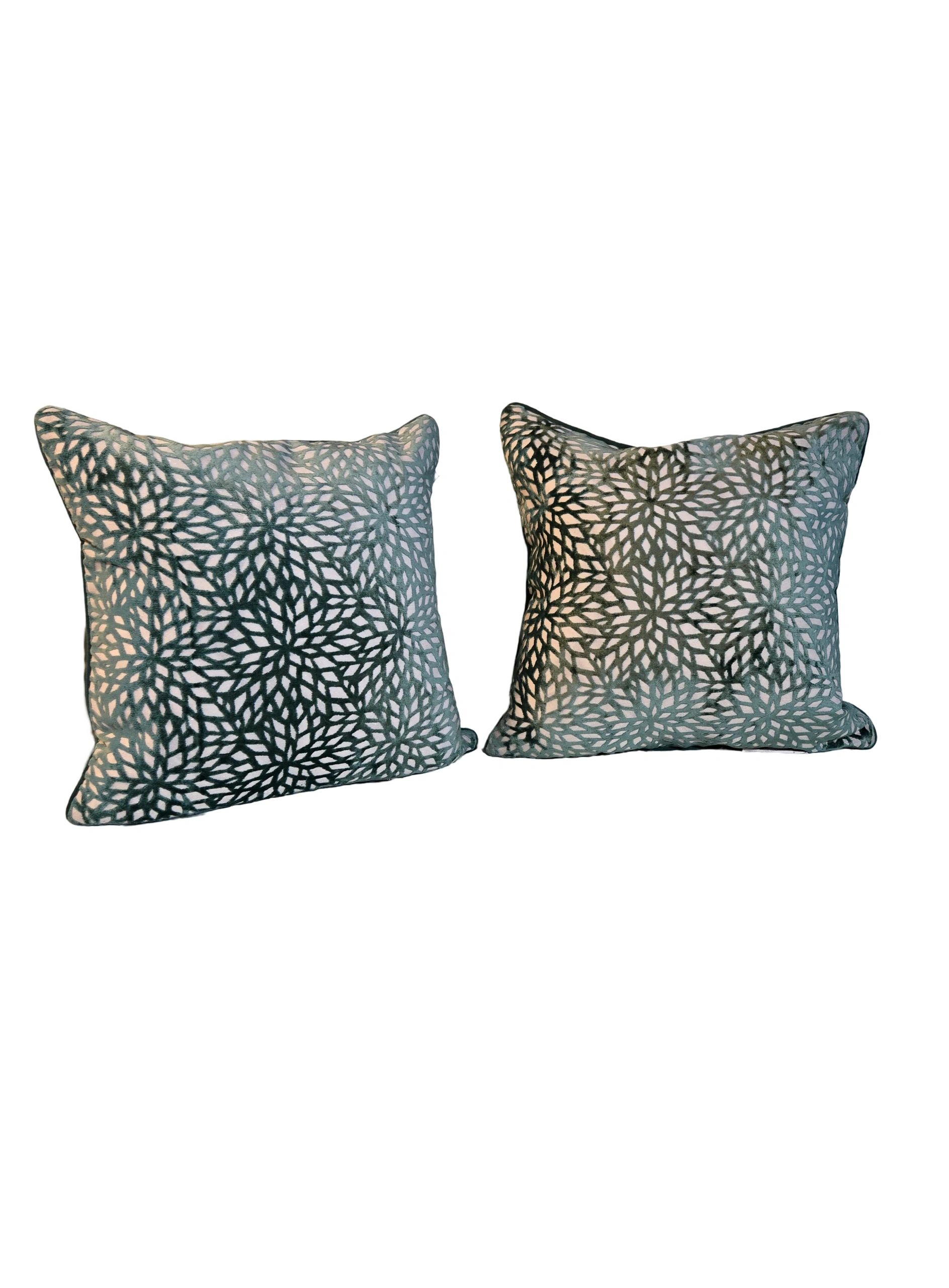 A pair of pillows with animal print on them.