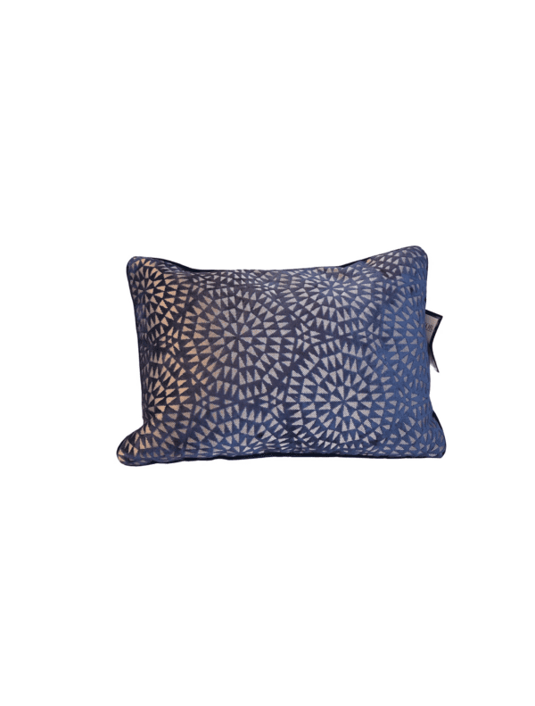 A pillow with a blue and white pattern on it