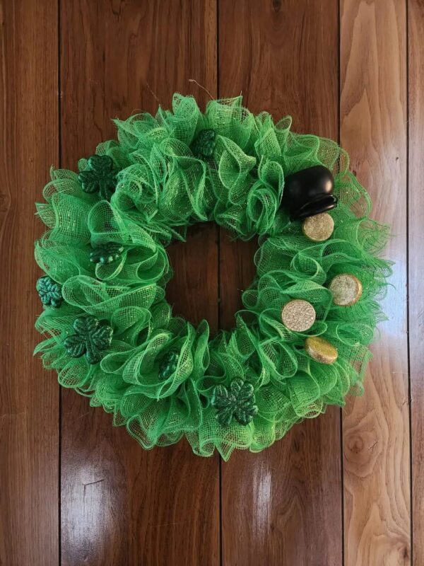 A green wreath with lemons and other decorations.