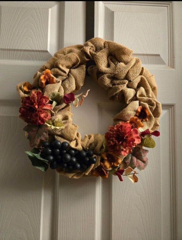 A wreath hanging on the door of a house.