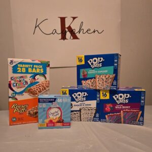 A table with several boxes of cereal and other items.