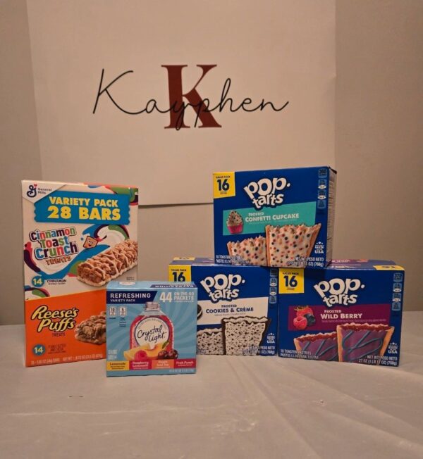A table with several boxes of cereal and other items.