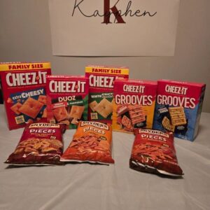 A table with several bags of cheez its and other snacks.
