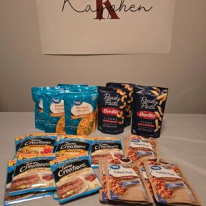 A table with several bags of food and two packages.