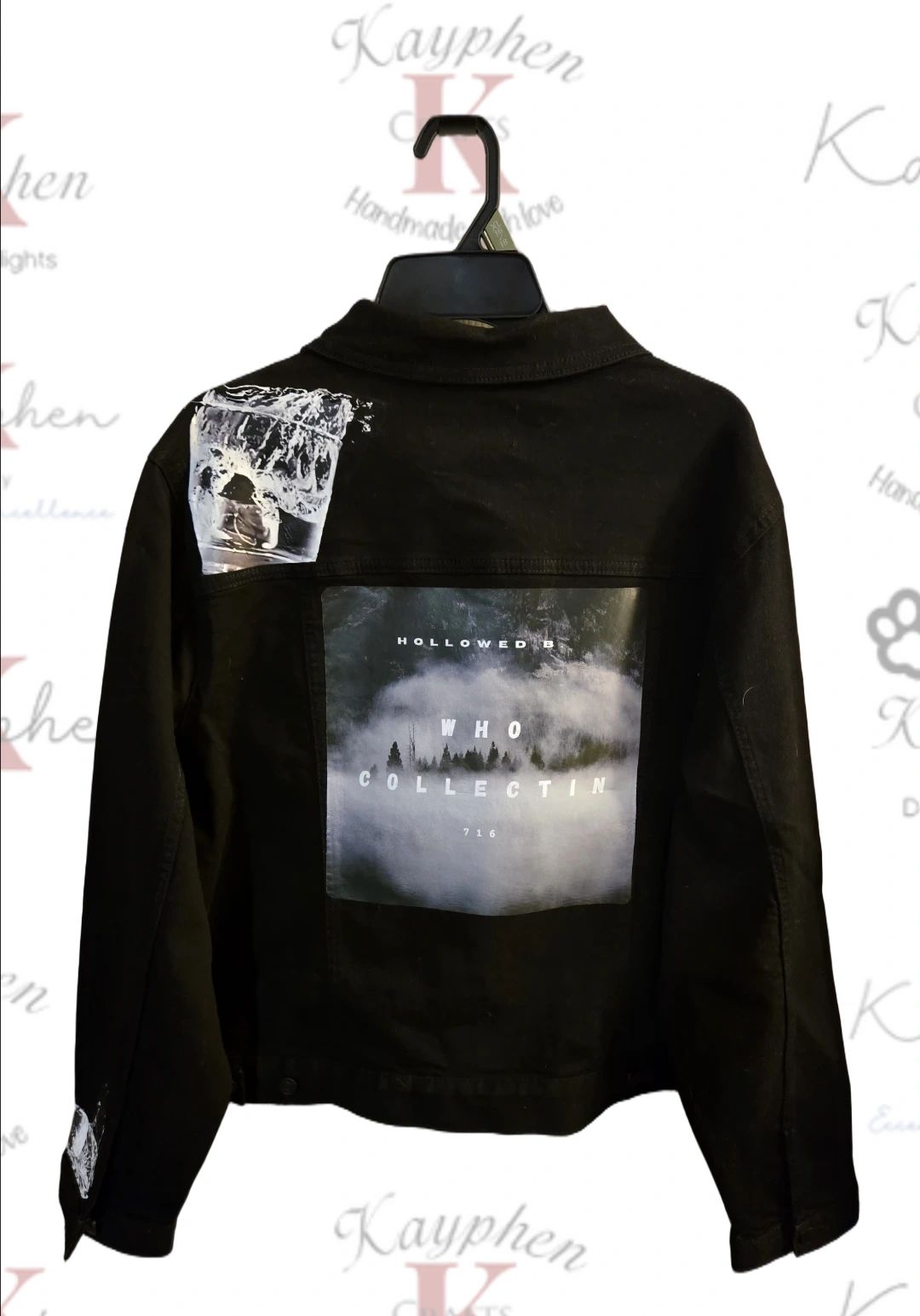 1000010166 A black jacket with a picture of people in the middle.
