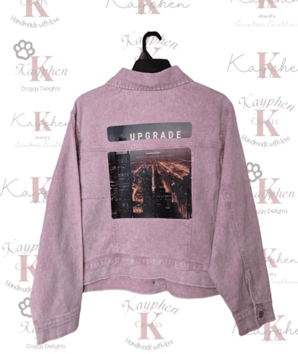 A pink sweater with the word upgrade on it.