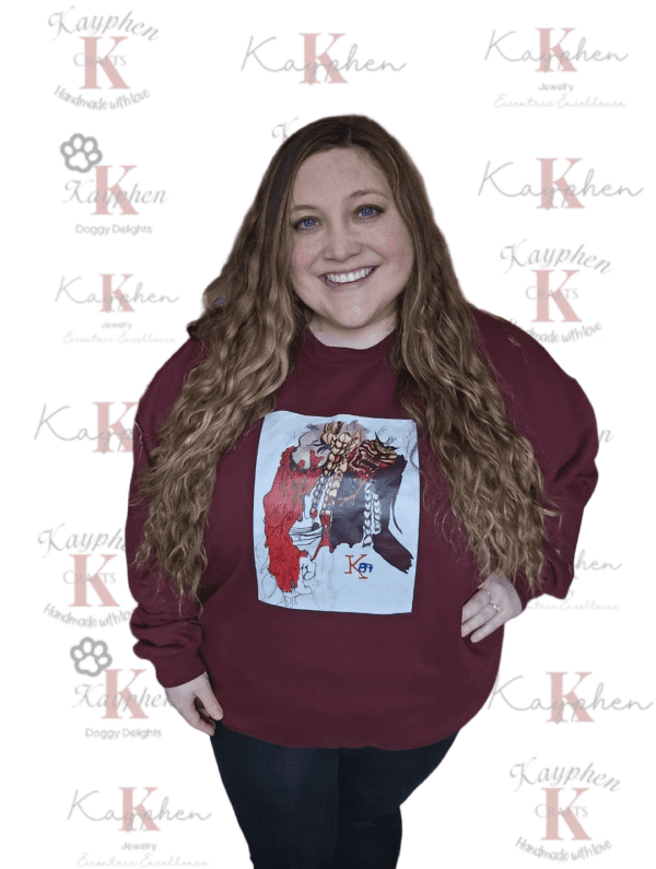 A woman standing in front of a maroon background.