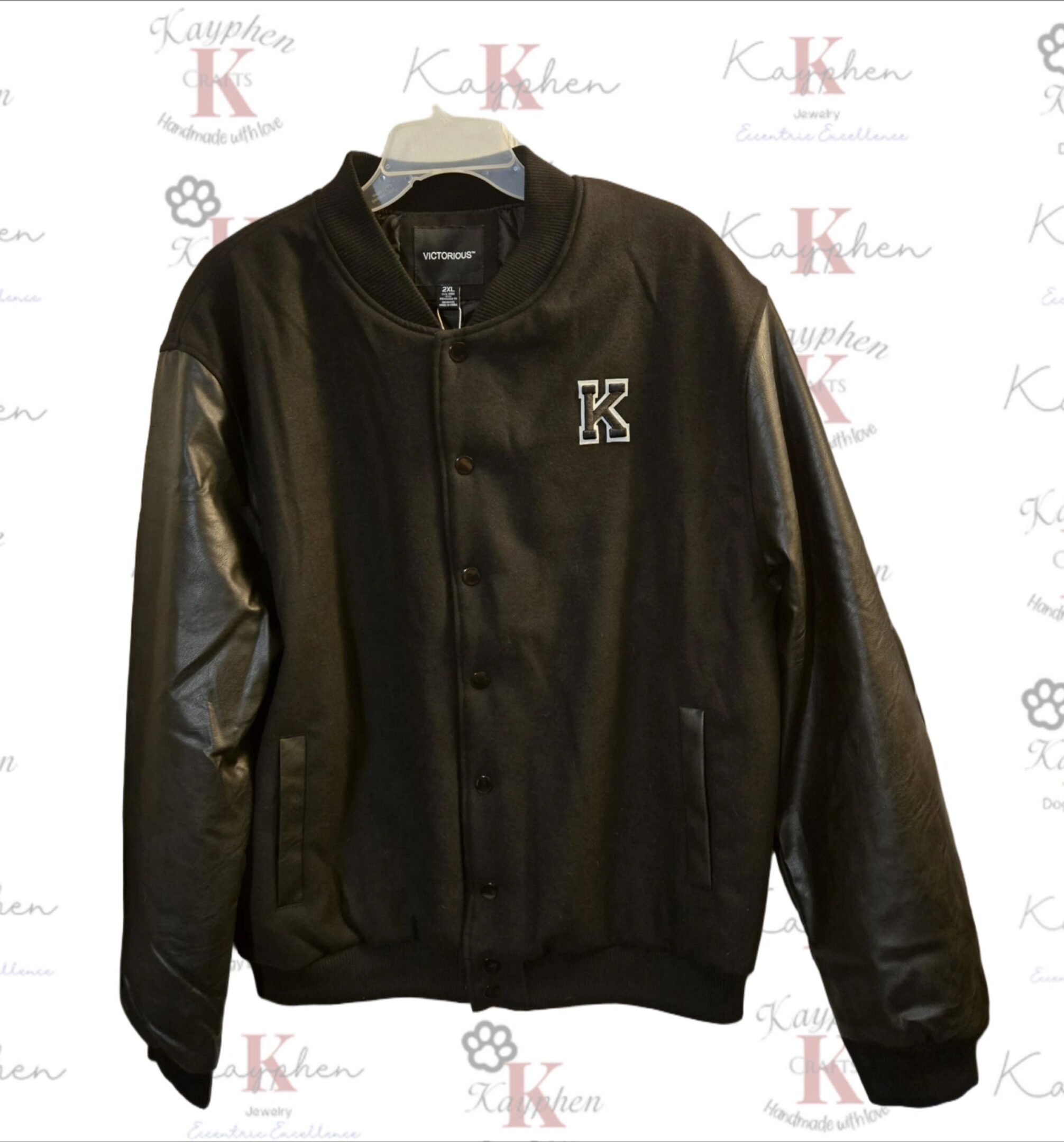 1000011051 A black jacket with leather sleeves and a k logo.