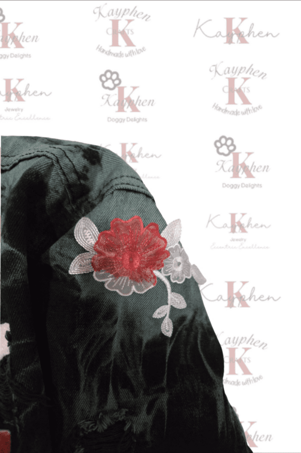 A close up of the back of a jacket with a flower on it.