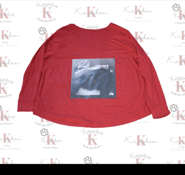 A red long sleeve shirt with an image of a bear.