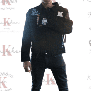 A man in black jacket and jeans standing on the red carpet.