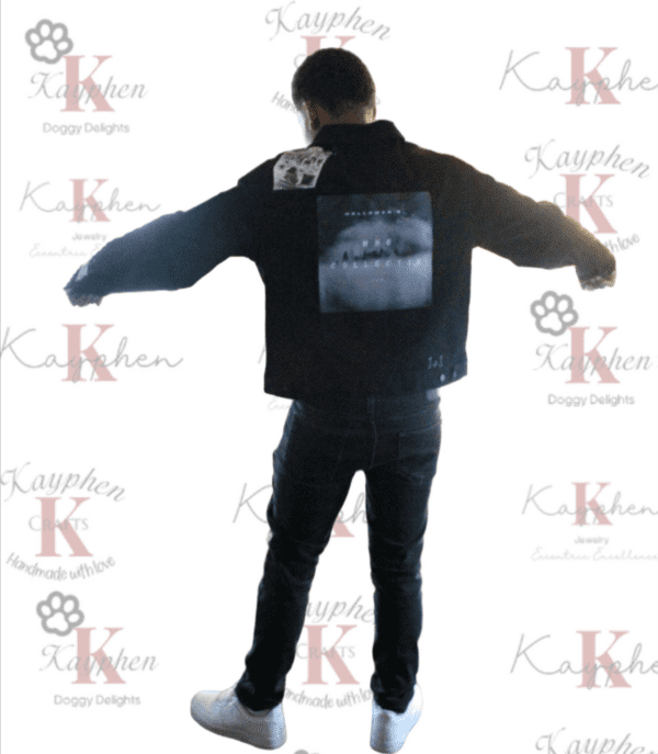 A man standing in front of a wall with his arms outstretched.