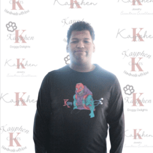 A man standing in front of a wall with the word " k " on it.