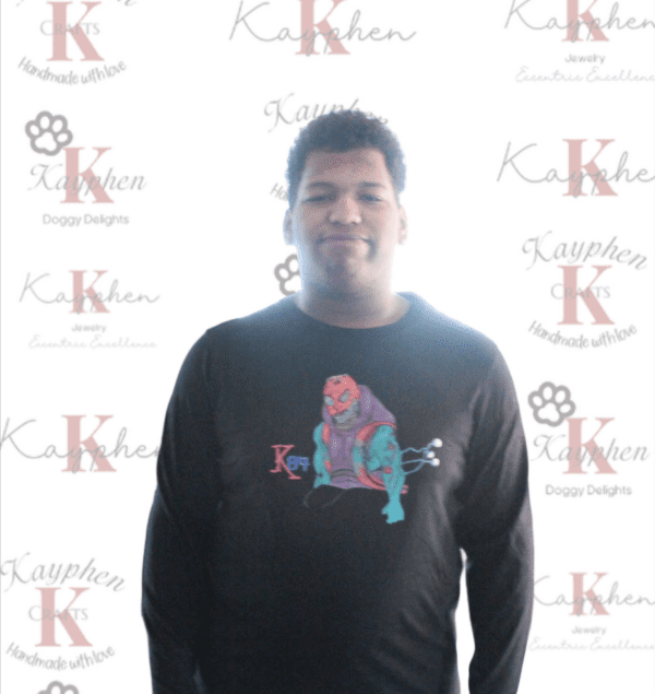 A man standing in front of a wall with the word " k " on it.