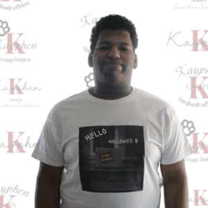A man wearing a white shirt with the words " hello " on it.
