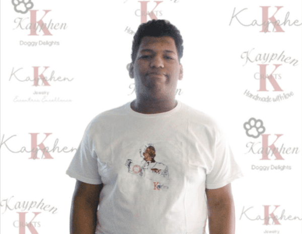 A man wearing a white t-shirt with an image of a dog.