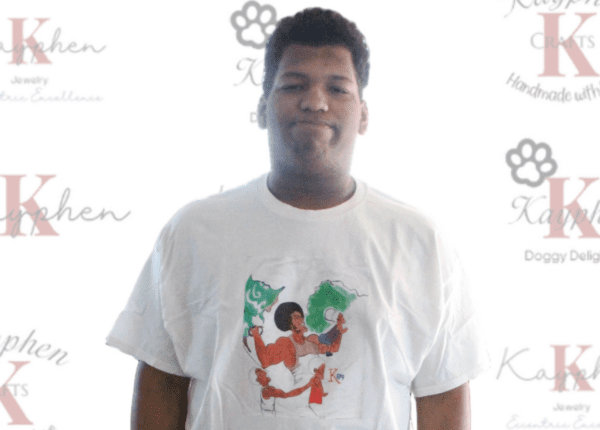 A man wearing a t-shirt with an image of a person holding something.