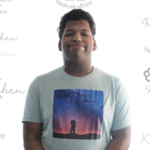 A man standing in front of a wall with words on it.