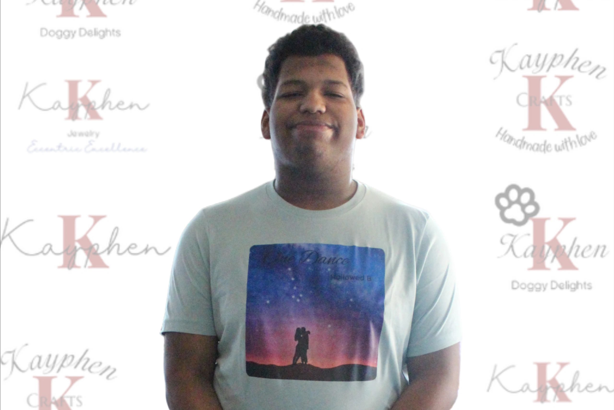 17419075814362 A man standing in front of a wall with words on it.