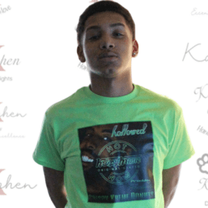 A man wearing a green t-shirt with the word " kitchen " on it.