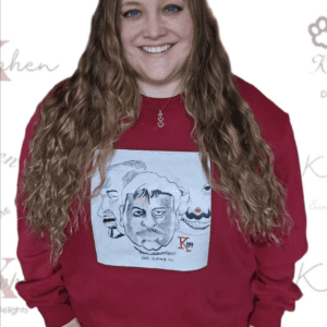 A woman with long hair wearing a red sweatshirt.