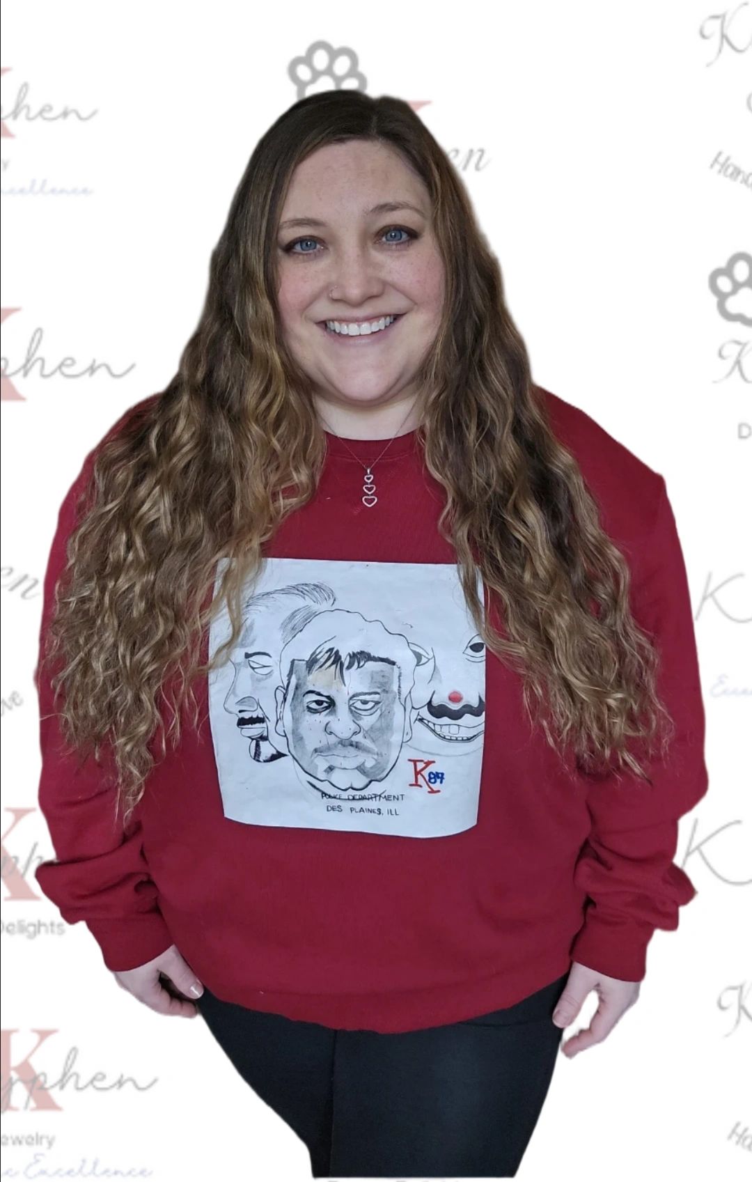 A woman with long hair wearing a red sweatshirt.