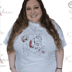 A woman wearing a white t-shirt with an image of a person.