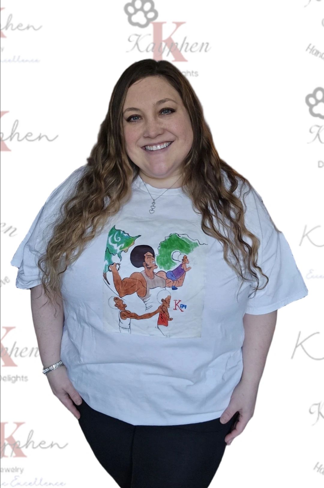 A woman wearing a white t-shirt with an image of a person and cat.