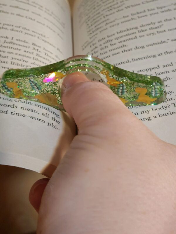 A person is holding onto the book page