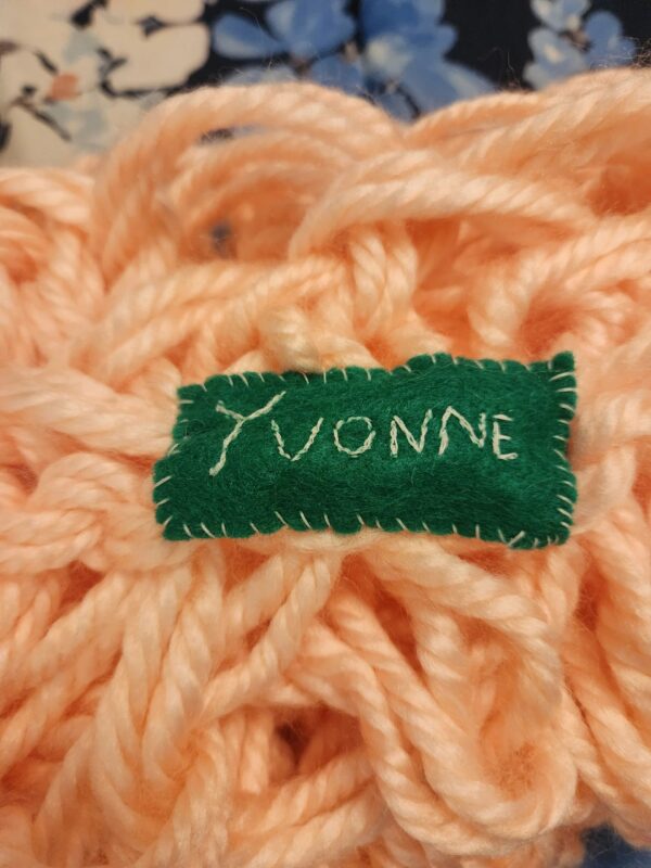 A close up of the name yvonne written on yarn.