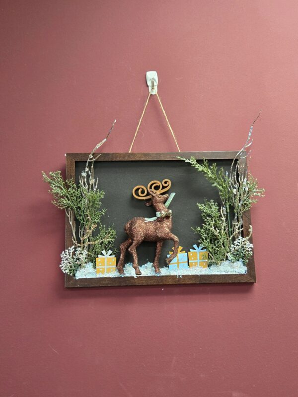 A framed picture with a deer on it