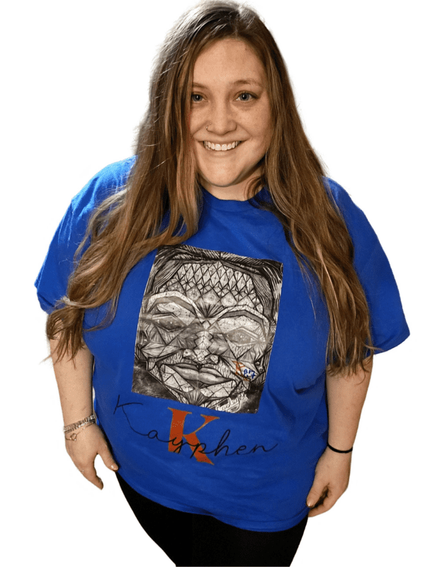 A woman wearing a blue shirt with an image of buddha.