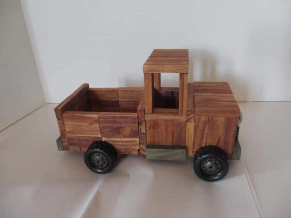 A wooden truck with a window open on top of it.