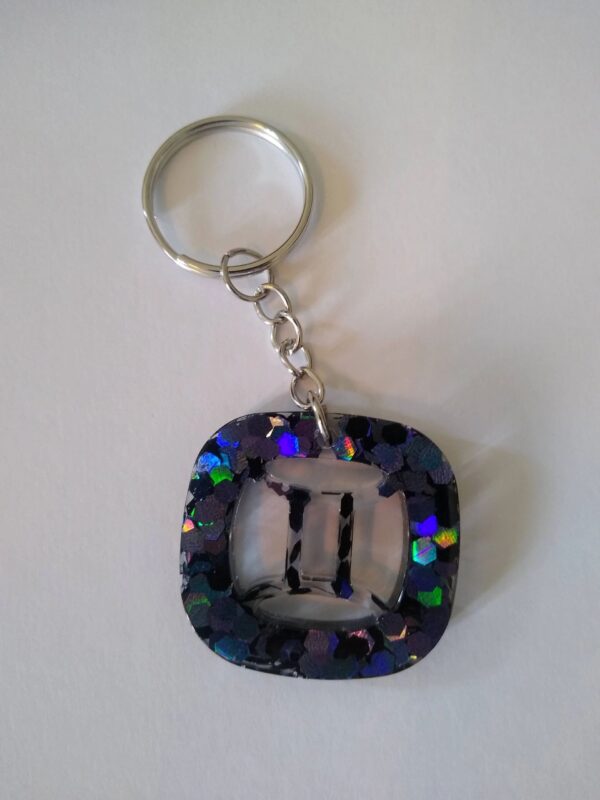 A key chain with the number two in it.