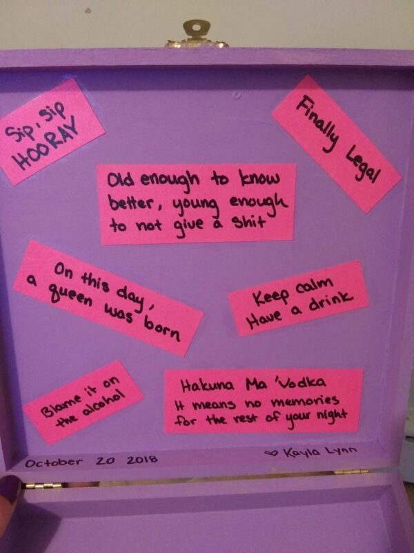 A purple board with pink sticky notes on it