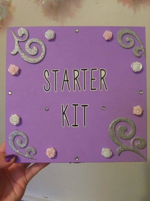 A purple sign with flowers and swirls on it.