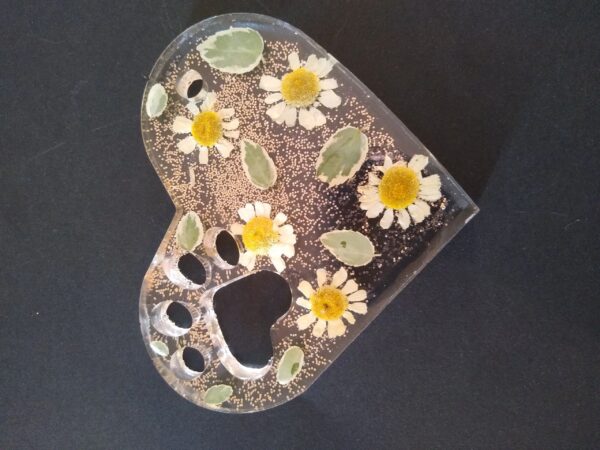A heart shaped dish with flowers on it.